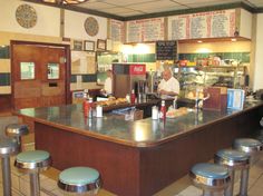 a man is behind the counter in a restaurant