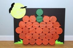 a pumpkin made out of toilet paper on top of a black board with the words poke - a - pumpkin game