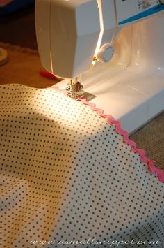 the sewing machine is sitting on top of the table with polka dot fabric around it