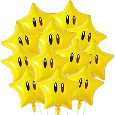 a bunch of yellow balloons with faces drawn on them are arranged in the shape of starbursts