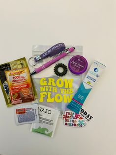 the contents of a personal care kit laid out on a white surface, including toothbrushes and other items