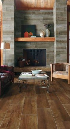 a living room filled with furniture and a fire place next to a wall mounted fireplace