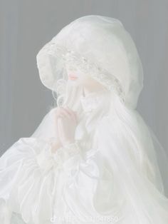 a doll dressed in white is wearing a veil and holding her hands to her face