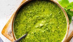 a wooden bowl filled with green pesto