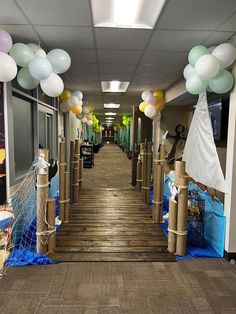 the hallway is decorated with balloons and streamers for an ocean themed birthday or baby shower