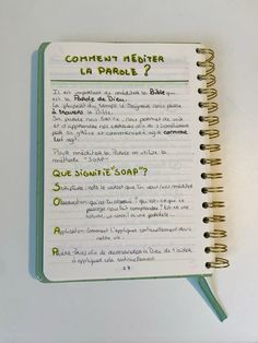 an open notebook with writing on it and the words comment never la parole written in french