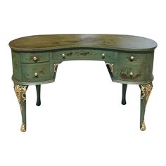 an antique desk with two drawers on one side and gold accents on the other end