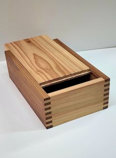 a small wooden box with two compartments on the front and one drawer in the back