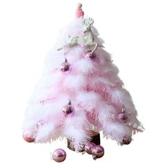 a pink and white christmas tree with ornaments on the top is shown in front of a white background