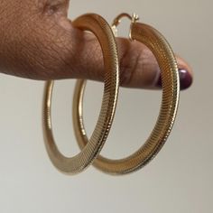 Get ready to steal the spotlight with our Queen Hoop Earrings in medium! These hoop earrings are a statement! Plus, you can choose between a large or medium size – both will dress up your look! The medium size adds just the right amount of glamour without going overboard. But if you're all about making a grand entrance, go for the large size and soak up all the attention! These earrings are your ticket to turning heads and feeling amazing! Gold layered textured hoop earrings Secure latch backing 1.5" Medium hoop Ships from N.Y. and is usually delivered within 5 business days of placing order. See our Care & Handling for care instructions and FAQs page for warranty details. Chic Metal Hoop Earrings, Trendy Hoop Earrings For Party, Small Hoop Earrings For Fashion, Chic Hoop Earrings For Party, Chic Small Hoop Earrings For Party, Glamorous Metal Hoop Earrings, Hoop Earrings Medium, Hoop Earrings Large, Large Hoop Earrings