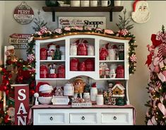 a white hutch filled with christmas decorations and candy canes on top of it