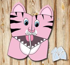 a paper cut out of a pink tiger with its mouth open and tongue hanging out