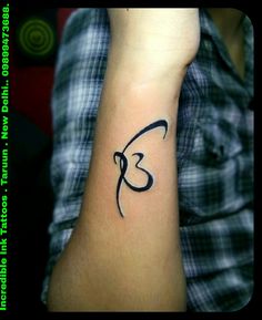 a person's arm with a tattoo on it that has the letter k in cursive writing