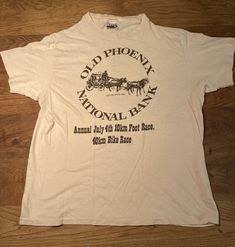 1980's Old Phoenix National Bank July 4th 10k race tshirt.  Sponsored by YMCA. Vintage Hanes tshirt.  Men's L, 42-44.  Much closer to a smedium! Wow!! What a great tshirt, Cool shear color with brown logo!!  100% cotton Vintage Sports T-shirt With Logo Print, Vintage Crew Neck Sports T-shirt, 10k Race, Vintage Running, Banks Logo, Vintage Bank, Vintage Michigan, Brown Logo, Browning Logo