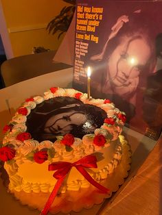 a birthday cake with a candle on it and a card in the background that reads,