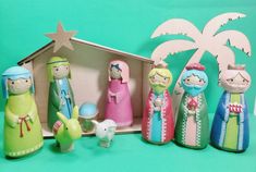 a group of figurines sitting next to each other on a green surface with a palm tree