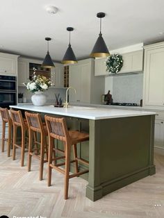 a large kitchen with an island and bar stools