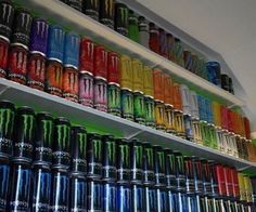 the shelves are filled with many different colored cans