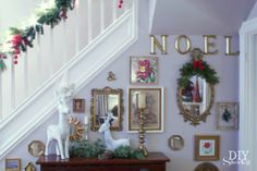 christmas decorations on the wall next to a bannister and staircase case in a home