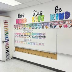 a whiteboard with writing on it is in the middle of an office cubicle