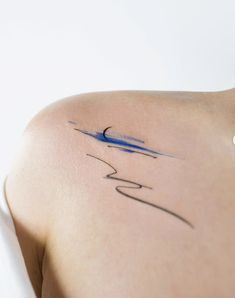 the back of a woman's shoulder with a tattoo on her left arm and an airplane drawn on it