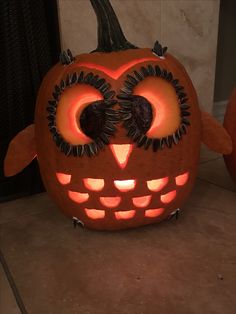 a carved pumpkin with an owl face on it