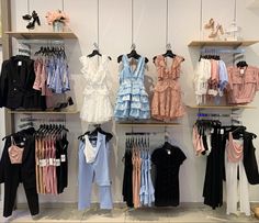 clothes are displayed on shelves in a store