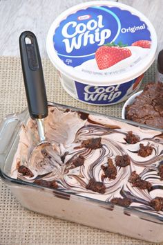 an ice cream sundae with chocolate and strawberries in it next to a container of cool whip