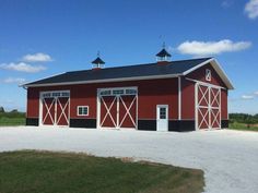 a red barn with two doors and three windows