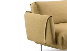 a beige couch with wooden legs and armrests