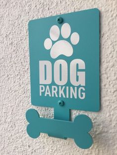 a sign that says dog parking with a paw on it