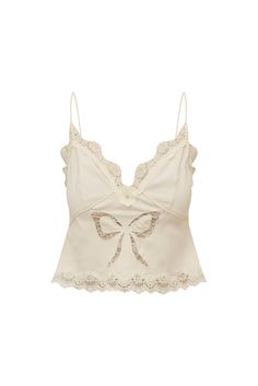 Feeling cute in the Fox Top. This sweet, bias cut cami top is designed with a luxurious, lightweight crepe fabric with an embroidered lace bow at center front. The slim top features empire seams, adjustable spaghetti straps, and scallop detailing at the neckline and the hem.