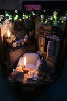 a miniature living room with a lit candle