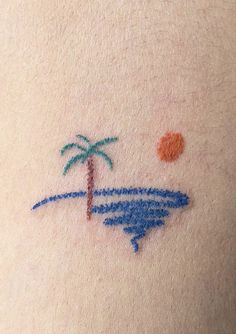 a small tattoo on the back of a woman's stomach with a palm tree and surfboard