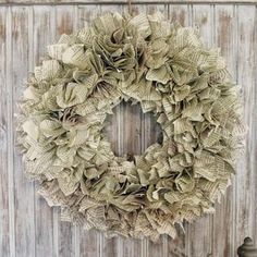 a wreath hanging on the side of a wooden wall