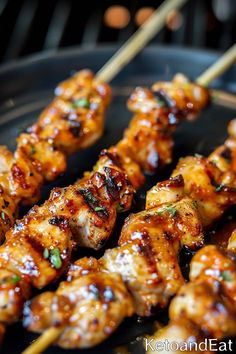 chicken skewers are being cooked on the grill