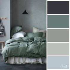 a bedroom with gray walls and green bedding in shades of blue, grey, and white