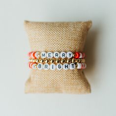 * Festive Christmas bracelet stack * Show your Christmas spirit with our MERRY & BRIGHT stack * Lightweight & easy to wear stretch bracelets * Handmade in North Carolina * Perfect for holiday parties, stocking stuffers, and White Elephant gift exchanges! * Custom sizes available  Click to see our entire Christmas Collection: https://www.etsy.com/shop/KelseyOBrienDesigns?ref=seller-platform-mcnav&section_id=39995916 ---SIZING--- Select your desire size from the drop down menu. Don't see your desi Cheap White Bracelets For Christmas, Cheap Beaded Bracelets For Holiday, Festive Adjustable Personalized Bracelets, Gold Beaded Christmas Bracelets, Adjustable Gold Beaded Bracelets For Holiday, Holiday Jewelry With Letter Beads, Holiday Jewelry With Letter Round Beads, Personalized Adjustable Beaded Bracelets For Christmas, Holiday Jewelry With Round Letter Beads