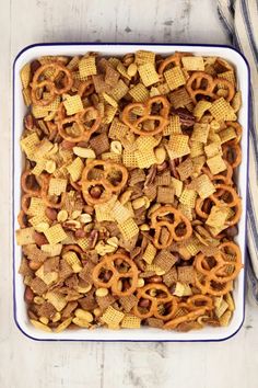 a casserole dish filled with cheetos and pretzels