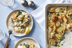 a casserole dish with chicken and spinach in it on a blue table cloth