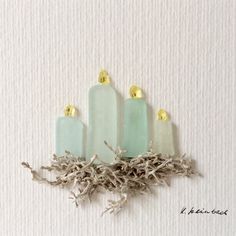 four candles sitting on top of some twigs