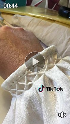 a person wearing a watch on their wrist with the words tik tok in front of them