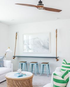 a living room filled with furniture and a ceiling fan