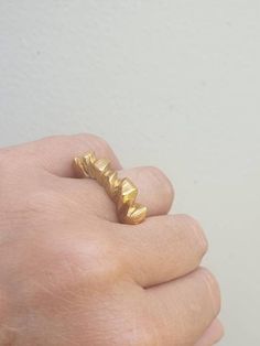 This is a beutifull 14 karat gold plated brass, woman's ring. a rock shape ring with a rustic look. It is a statement ring in a matt finish. -14 k gold plated brass-free shipping worldwide-gift boxIf you would like to see other rings I have made, please follow this link:https://www.etsy.com/il-en/shop/TamyZurTachshit?ref=seller-platform-mcnav&section_id=17271018If you would like to go back to my store follow this link: https://www.etsy.com/il-en/shop/TamyZurTachshit?ref=seller-platform-mcnav Unique Faceted Gold Rings, Etsy Jewelry Rings, Raw Design, Faceted Ring, Sparkly Ring, Sterling Silver Stacking Rings, Stacking Ring Set, Casual Jewelry, Gift Inspiration