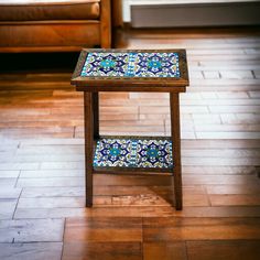 a wooden table sitting on top of a hard wood floor next to a couch in a living room