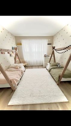 a room with two beds and a rug on the floor