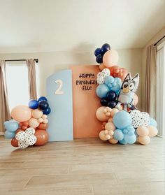 an animal themed birthday party with balloons and streamers on the floor in front of it