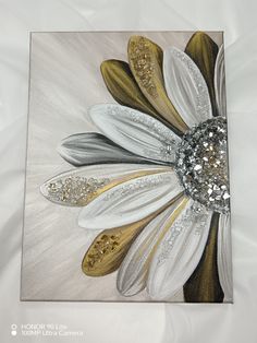 a painting with white and gold flowers on it