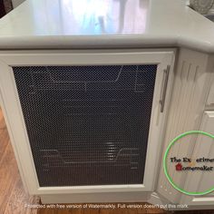 a white kitchen island with an oven on it's side and a green circle in the middle