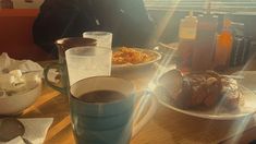 a table topped with plates of food and drinks